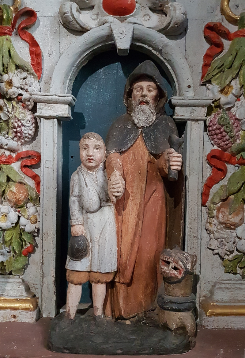 Statue of Saint Hervé with his guide, Guiharan, and his wolf. Church of Saint-Miliau, Guimiliau